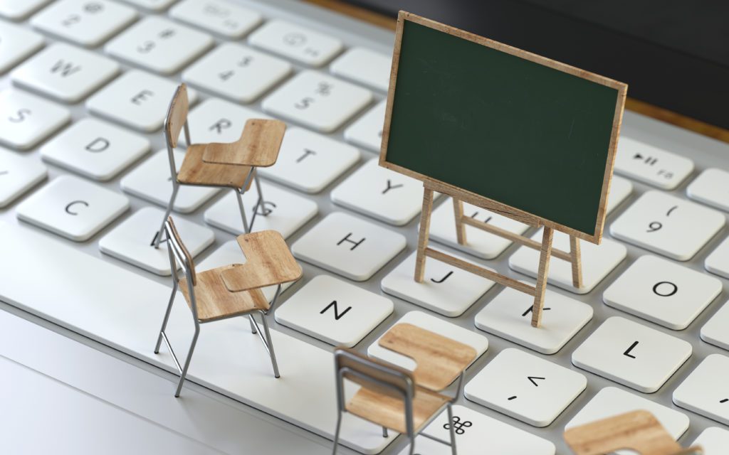 Mini blackboard and chairs on the keyboard of a latop